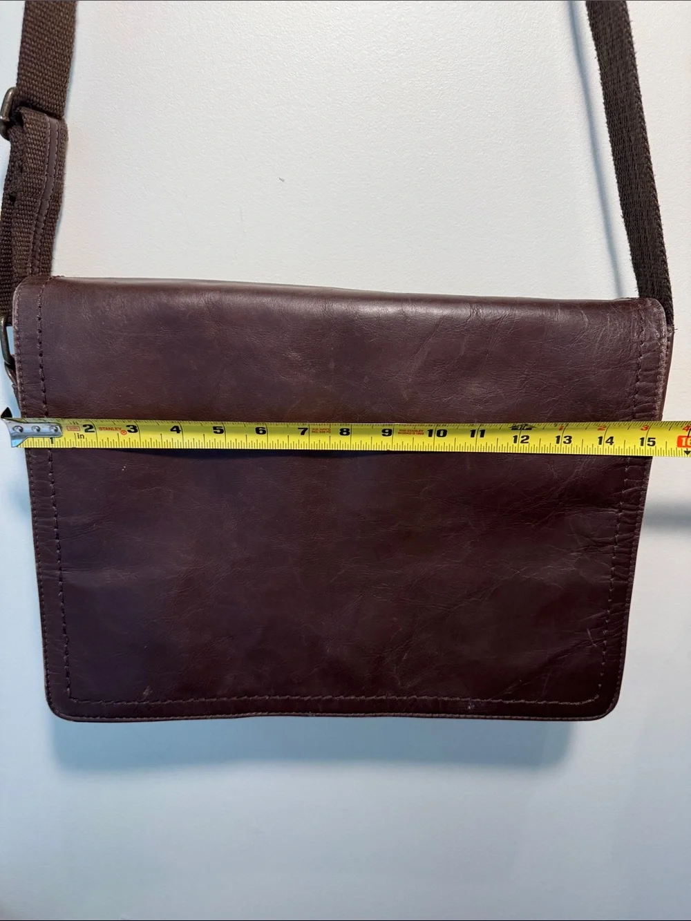 Wilson’s Leather chocolate brown messenger bag with webbed adjustable strap.